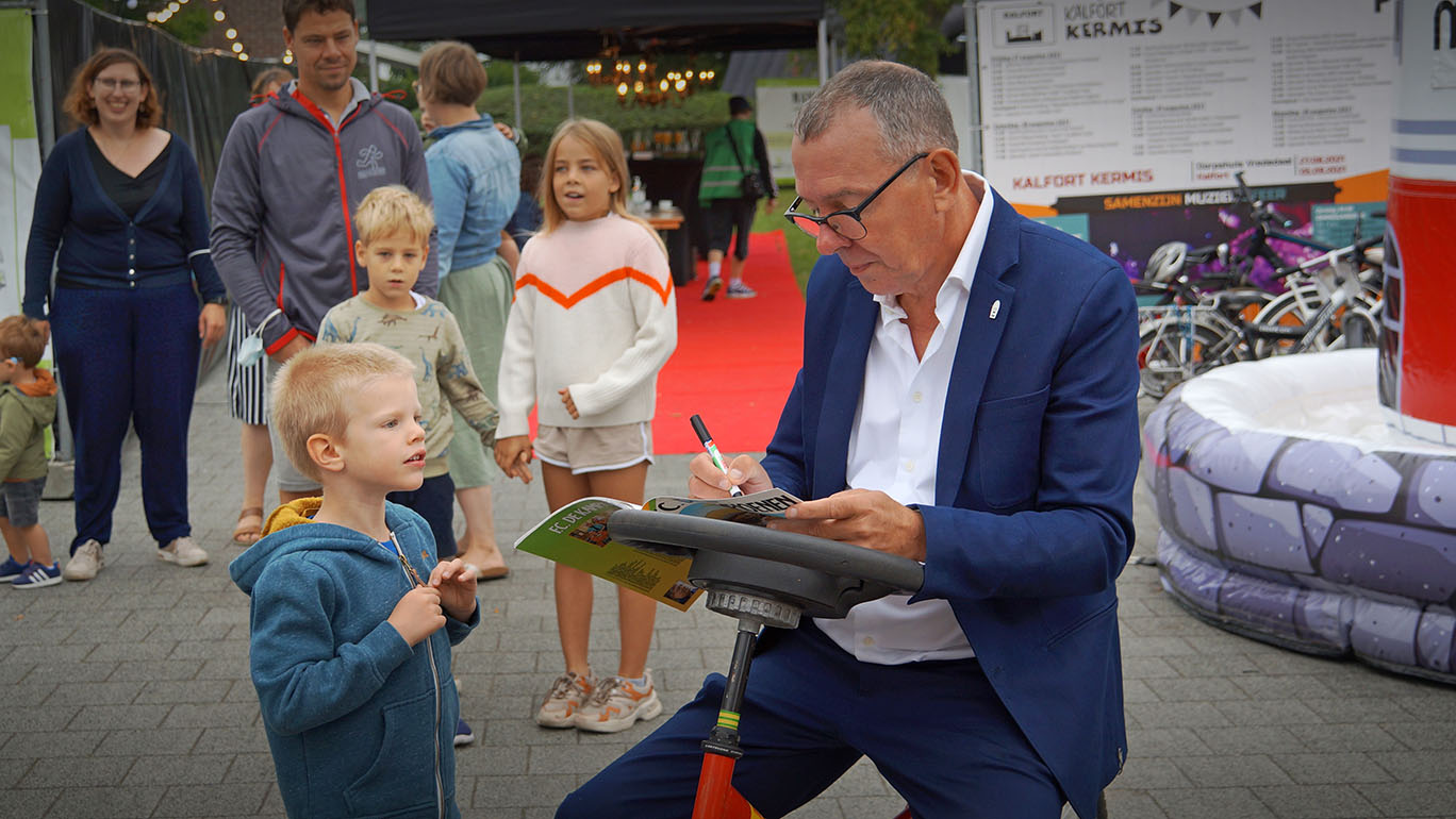 Artiest Gene Thomas geeft handtekening aan kind op Kalfort Kermis